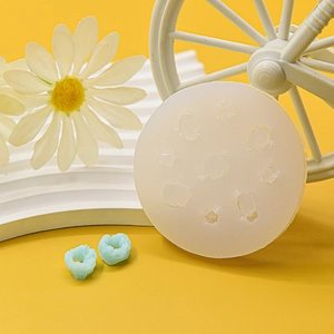 Multi-cavity silicone donut mold for chocolate and fondant cake decorating on yellow background