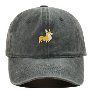 Detailed view of embroidery showing a cute corgi on washed dark grey cotton baseball cap