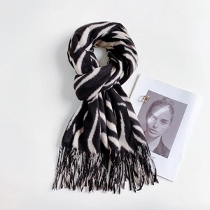 Detailed view of striped cashmere scarf with fringe texture on a minimalist layout