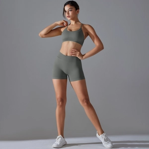 Detail of greyish green ribbed knit yoga set featuring a strapless sports bra and high waist shorts