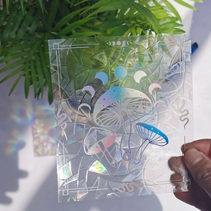 Detailed holographic mushroom suncatcher decal reflecting vibrant rainbow colors on glass
