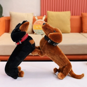 Cute lifelike dachshund plush toy in black and brown with decorative collars on a sofa