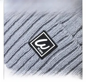 Close-up of grey ribbed knit beanie with warm fleece lining and woven brand label