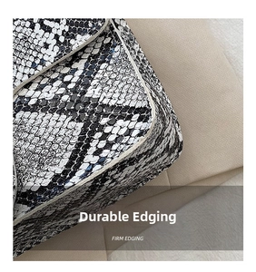Detailed close-up showing firm edging and snakeskin pattern on a vintage crossbody bag