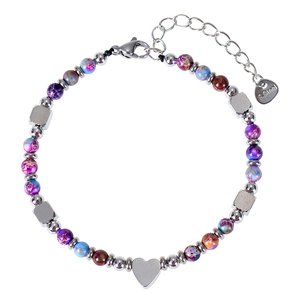 Macro detail of natural stone beaded bracelet with heart pendant and lobster clasp closure