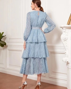 Detail of blue layered tiered dress with fringe feather texture and elegant draping