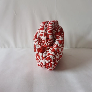 Macro shot of red and white thick cotton yarn crochet texture on handmade cloud bag