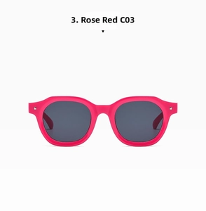 Close-up of rose red punk hip hop sunglasses with dark grey lenses and silver studs