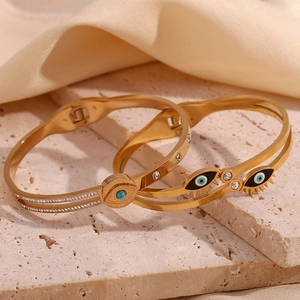 Macro shot of 18K gold plated evil eye bangles with turquoise and enamel details