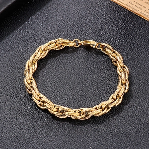 Close-up of golden braided heavy metal chain bracelet with detailed texture and lobster clasp