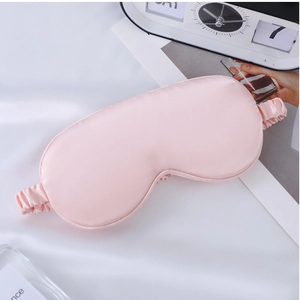 Pink faux silk sleep mask on white satin fabric with a modern flip clock detail