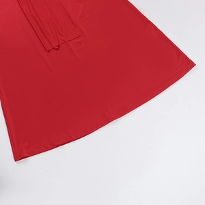 Close-up of red knitted dress hem showing professional stitching and elastic fabric