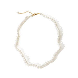 Macro shot of irregular freshwater pearls with a gold clasp and adjustable link chain