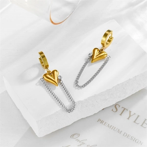 Modern gold heart drop earrings with silver chain and crystal on minimalist pedestal