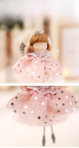 Macro detail of pink bubble skirt with silver sequins on a handmade Christmas angel doll