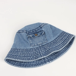 Close-up of denim bucket hat featuring a decorative small pocket and copper button