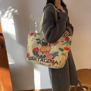 Detailed close-up of a large linen tote bag featuring a sloth and floral tropical print