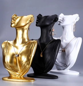 Detailed view of necklace bust displays in gold, black, and white finishes for jewelry store