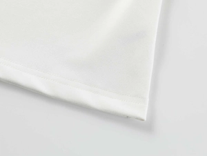 Detailed close-up showing the fine flat-stitch hem of the white square neck tank top