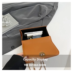Internal capacity view of orange quilted chain bag holding phone and card holder