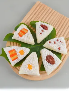 Detailed macro view of realistic PVC Zongzi food models on a wooden tray with green leaves