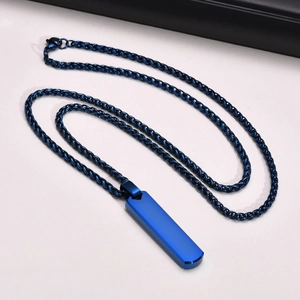 Macro shot of blue rectangle pendant on a stainless steel geometric necklace for men