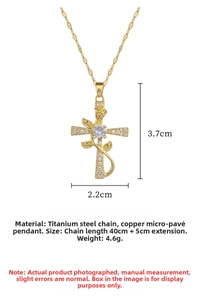 Macro detail of gold-plated rose cross pendant with white cubic zirconia inlay for women