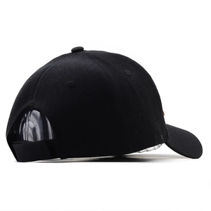Black cotton baseball cap with a six-panel design and adjustable strap from a side view