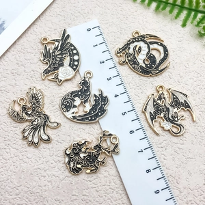 DIY black and white enamel animal charms with ruler for size reference and scale