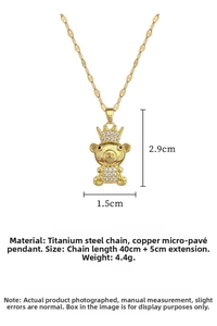 Detailed view of crown teddy bear pendant with dimensions 2.9cm x 1.5cm on gold chain