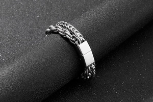 Detail of silver double-layered braided chain bracelet with a sleek magnetic clasp