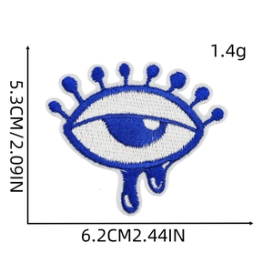Detail view of blue evil eye embroidery patch with dimensions 6.2cm x 5.3cm and 1.4g weight