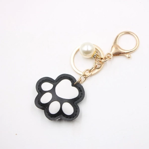 Cute black and white leather cat paw keychain with gold metal clasp and pearl detail