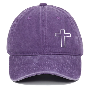 Detailed embroidery of a white cross on washed purple denim vintage baseball cap