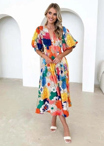 Detail of multi-color floral print dress with V-neckline and puff sleeves on white background