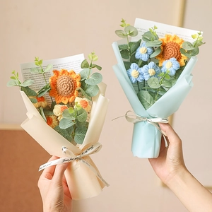 Hand-knitted sunflower and rose bouquet with colorful paper wrap and ribbons