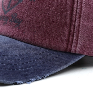 Macro shot of washed cotton baseball cap detailing vintage distressed brim and dual seams