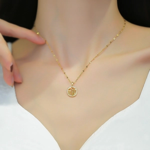 Titanium steel gold necklace with sparkling Fu pendant worn on a female model neck