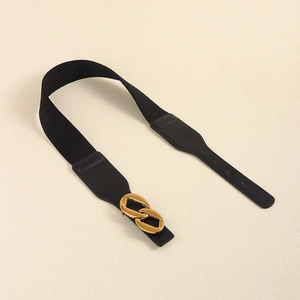 Close-up of black elastic waist belt with interlocking gold infinity buckle