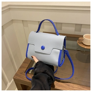 Detail of lychee pattern leather mini crossbody bag with blue contrast design