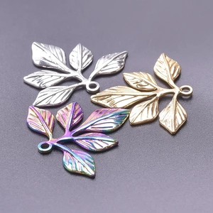 Three leaf-shaped stainless steel charms in gold, silver, and rainbow plating