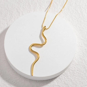 Creative minimalist 18K gold-plated stainless steel snake pendant necklace on white stand