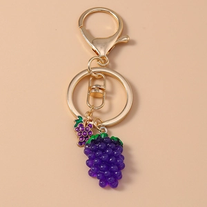 Detailed view of 3D purple grape pendant keychain with gold metal ring and lobster clasp