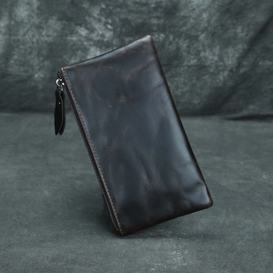 Detail shot of vintage dark brown crazy horse leather wallet with premium zipper closure