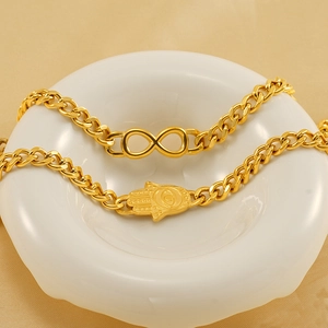 Bracelet en acier titane plaqué or 18 carats avec pendentifs infini et main de fatma
