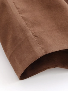 Macro detail of high-density stitching on the coffee brown woven fabric cuff of the blazer