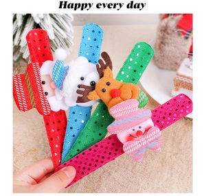 Close-up of colorful sequin Christmas slap bracelets with cartoon reindeer and snowman