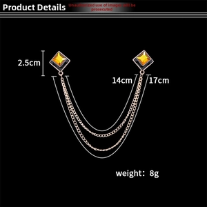 Detailed view of square gold brooch with yellow gemstones and 17cm tassel chain