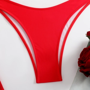 Detail of red bikini bottoms with elastic quick-dry fabric and neat white lining stitches
