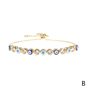 Detail of adjustable gold-plated evil eye bracelet with blue enamel and cubic zirconia